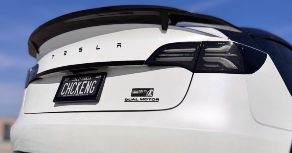 Your Guide to Digital License Plate Banner Messages 1 Image of a White Tesla with a Reviver RPLATE with a vanity plate that reads "Chck Eng," which is a reference to Check Engine Light.