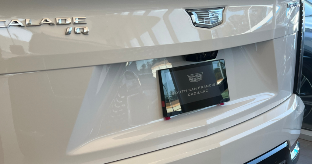 Luxury, Meet Tech: The Digital License Plate Lands at Cadillac of South San Francisco 2 Image of a White Cadillac Escalade with a digital license plate on the back.