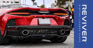 Image of a Red McLaren with a digital license plate at the Mother's Exotic Car Paddock 2025.
